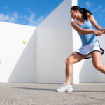 Girl Practicing A Backhand Against the Wall