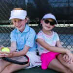 Two Children having fun on the tennis court