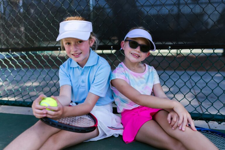Two Children having fun on the tennis court
